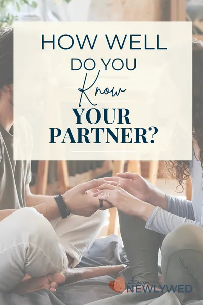 A couple looking at each other holding hands while they talk