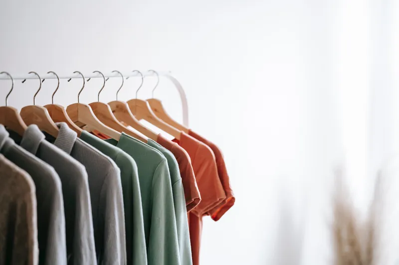An organized closet of colorful clothes