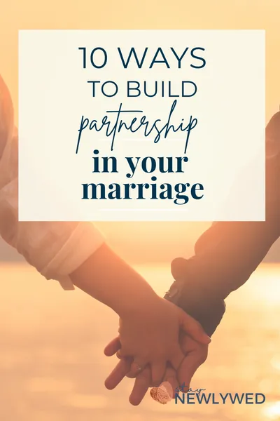 Couple holding hands in front of a sunset