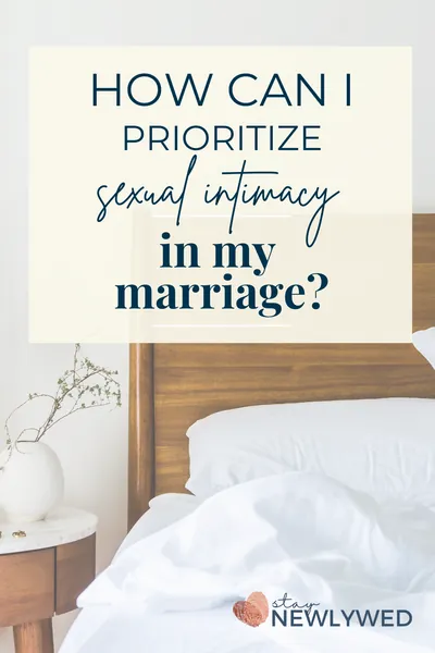 Ruffled white sheets on a bed with a plant in a vase on the side table